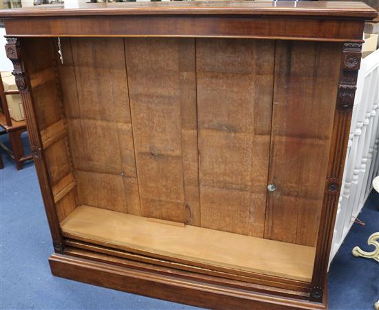 A Victorian carved walnut open bookcase, 116cm high